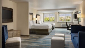 A hotel room with a large bed, a desk, a chair, and a TV. - Holiday Inn Express & Suites Colorado Springs Central by IHG (Colorado Springs)