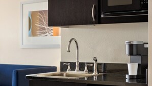 A modern kitchen with a stainless steel sink, a coffee maker, and a microwave. - Holiday Inn Express & Suites Colorado Springs Central by IHG (Colorado Springs)