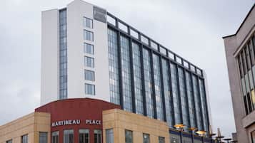 A multi-story hotel with a prominent Staybridge Suites sign on the top.