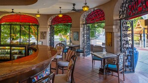 A restaurant with a curved bar, multiple seating areas, and decorative arches. - Casa del Rio Melaka (Malacca City)