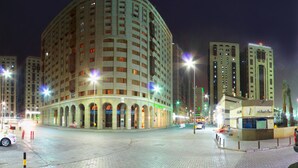 A large, multi-story hotel with a curved facade, multiple balconies, and a central courtyard. - Dallah Taibah Hotel (Madinah)