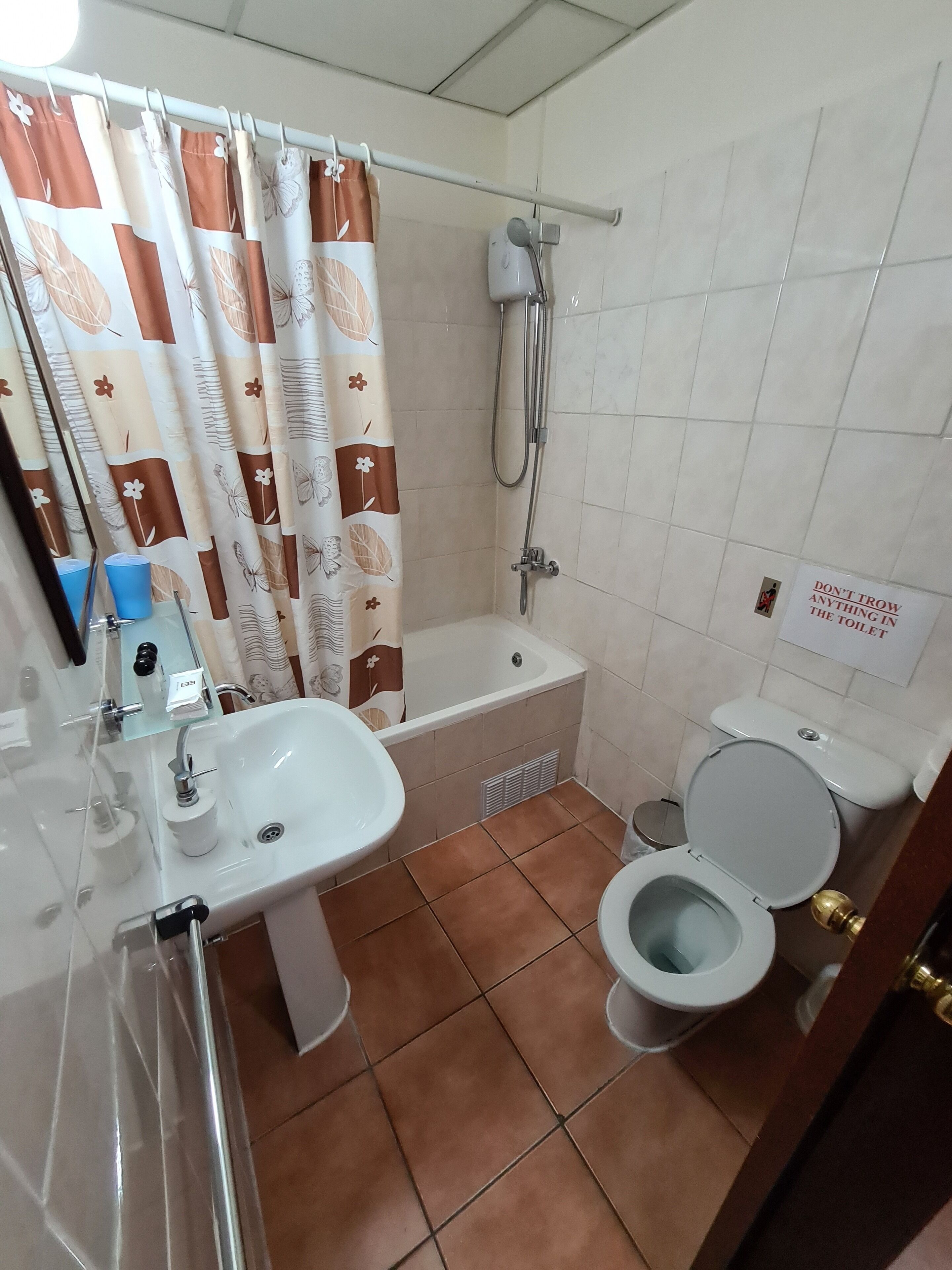 A bathroom with a bathtub, toilet, sink, and shower.