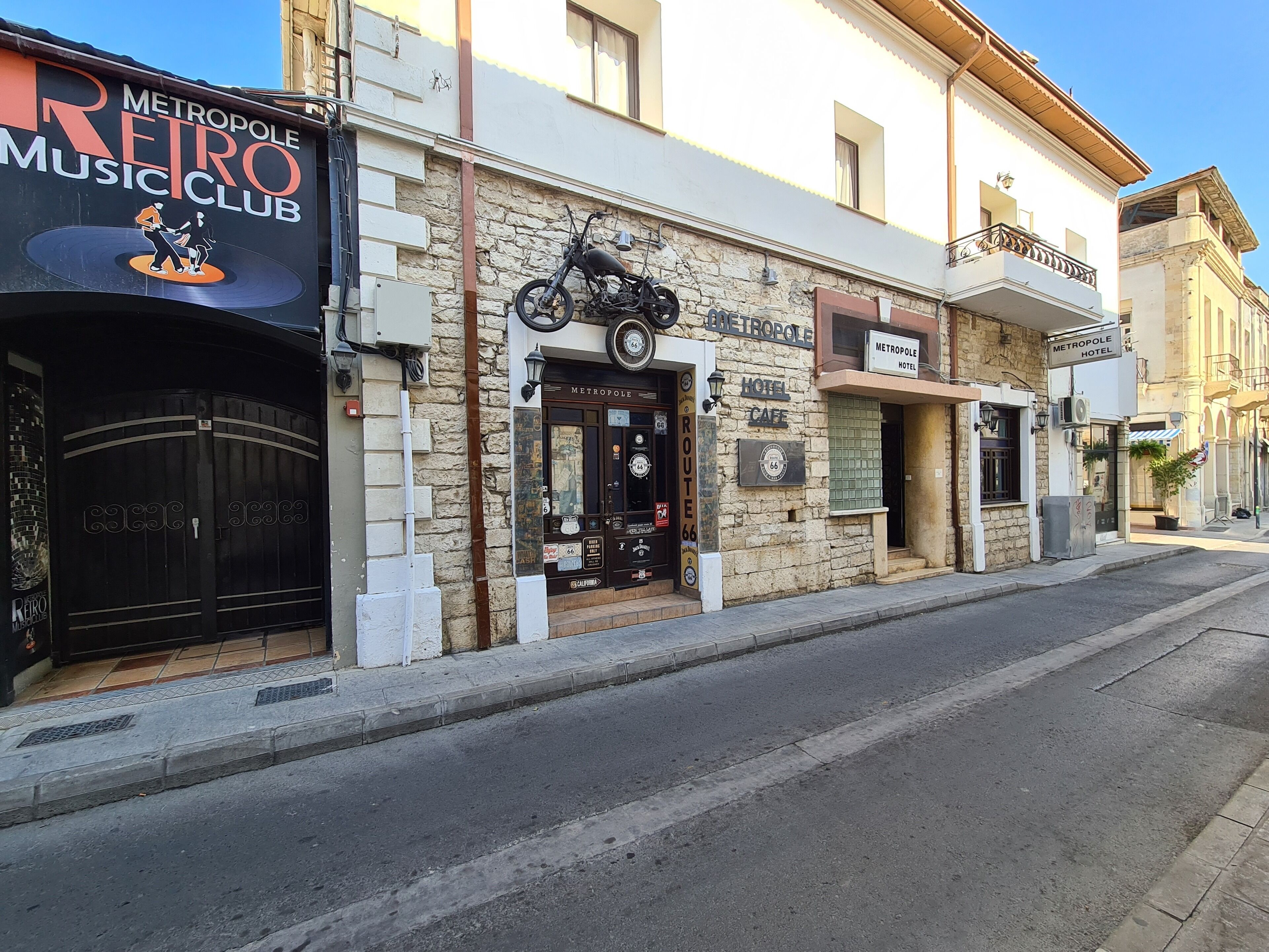A building with a sign for 'Metropole Hotel' and 'Metropole Music Club'.