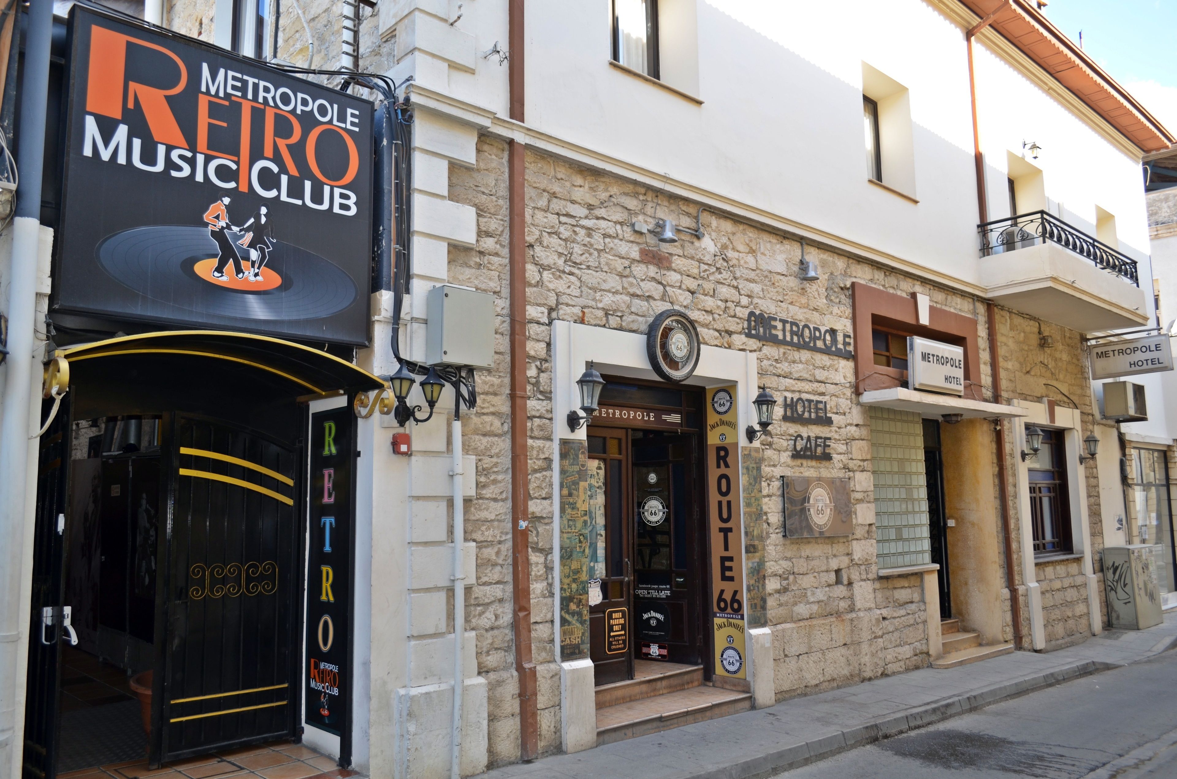 A building with a sign for 'Metropole Retro Music Club' and 'Metropole Hotel Cafe'.