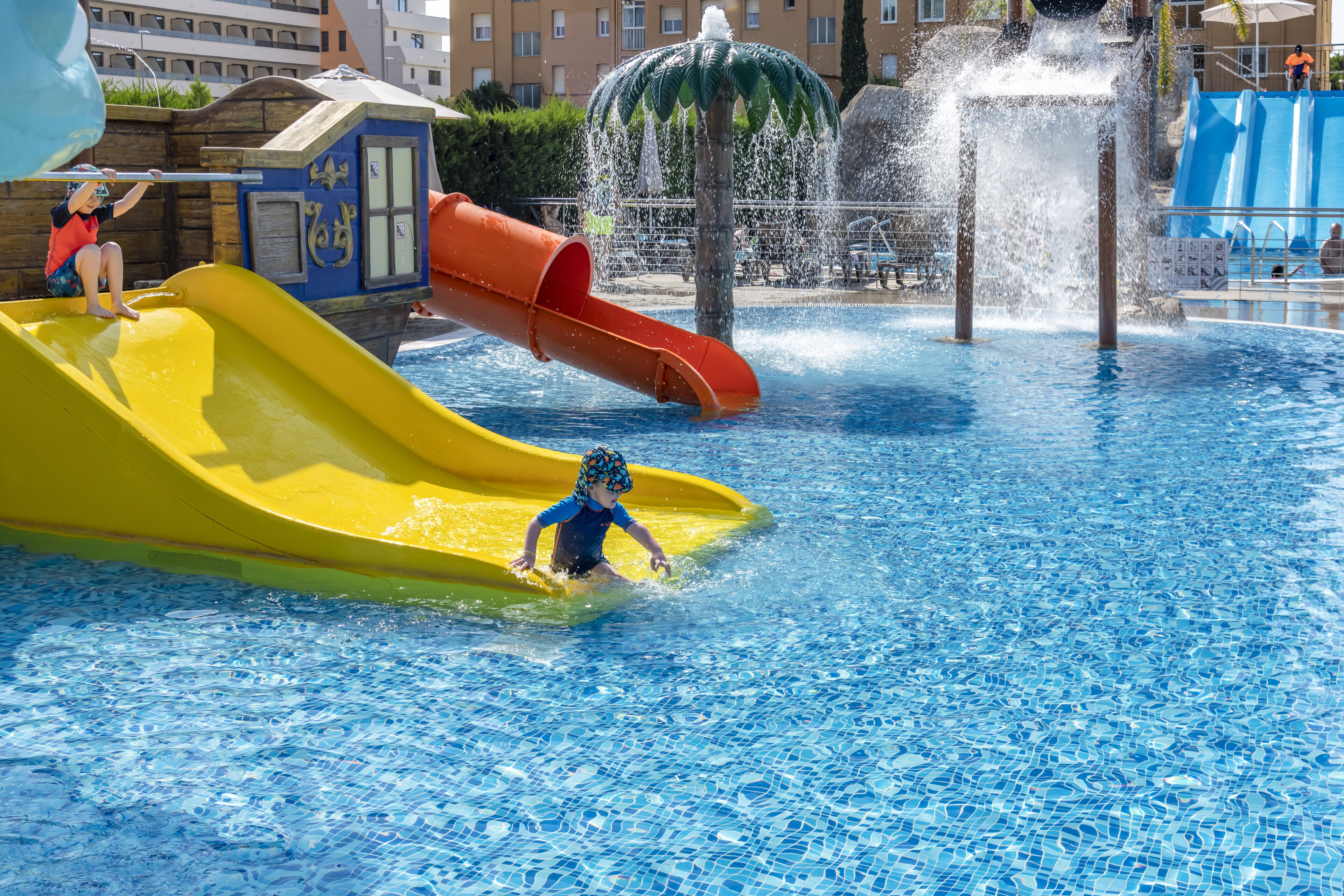 A water park with slides and a fountain.