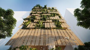 A hotel with a modern design, featuring a wooden slatted facade and lush greenery. -  Sky Gem Hotel Sora (Ho Chi Minh City)