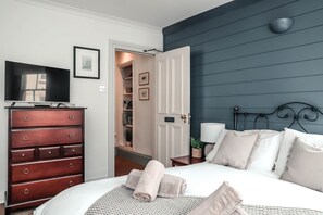 A bedroom with a bed, a dresser, a television, and a door leading to a closet. - The Endeavour Restaurant With Rooms (Saltburn-by-the-Sea)
