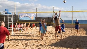 A beach volleyball game with players and spectators on a sandy court. - Monéa Royal Mónica (Yaiza)