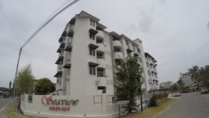 A multi-story apartment building named 'Seaview Apartment' with balconies, a gated entrance, and a sign indicating 'Tadika Shining Glory'. - Seaview Apartment (Langkawi)