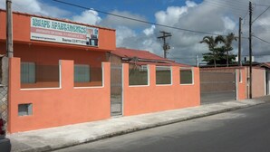 Un edificio con un letrero que anuncia apartamentos, una entrada con acceso restringido y un cielo despejado.