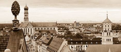 A cityscape with historic architecture, including a prominent church with a dome and a tall bell tower.