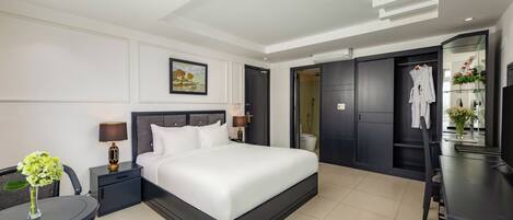 A modern hotel room with a large bed, bedside tables, a desk, and a chair.