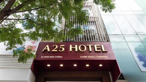 The exterior of A25 Hotel with a maroon signboard, contact numbers, and a glass facade. - A25 Hotel - 14 Pho Duc Chinh (Ho Chi Minh City)