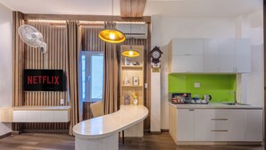 A modern kitchen with a built-in microwave, a sink, and a green backsplash. - A25 Hotel - 14 Pho Duc Chinh (Ho Chi Minh City)
