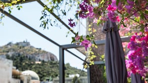 A view through a glass structure with a metal frame, overlooking a mountainous landscape with a dome-shaped building in the distance. - Athens Way Pop Art Hotel (Athens)