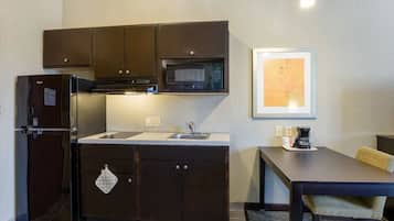 Fridge, microwave, coffee/tea maker, cookware/dishes/utensils