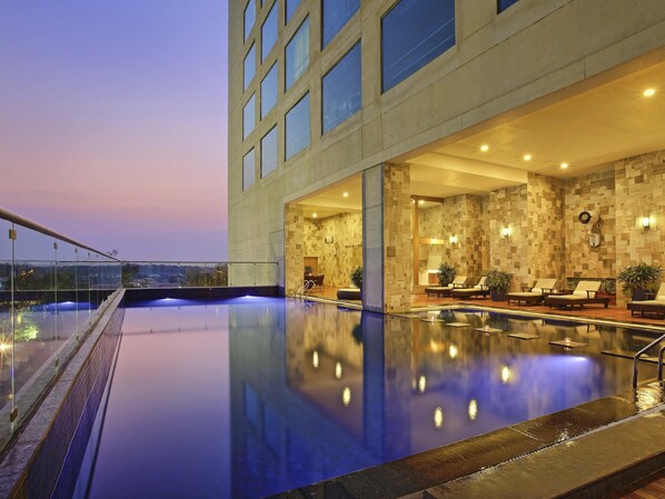 Outdoor pool, open 6:00 AM to 9:00 PM, pool umbrellas, pool loungers