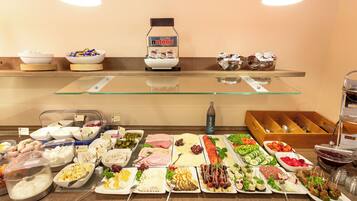 A buffet with various food items and a Nutella display.
