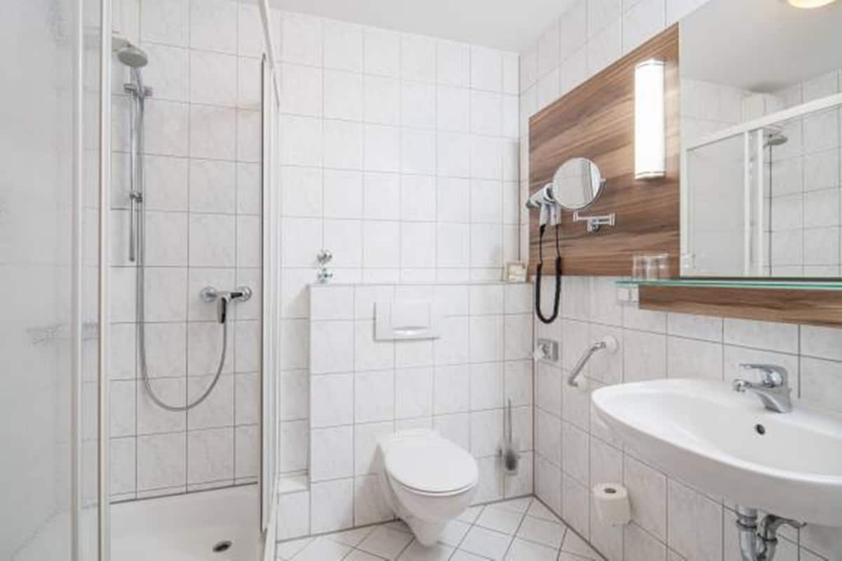 shower, hair dryer, slippers, towels