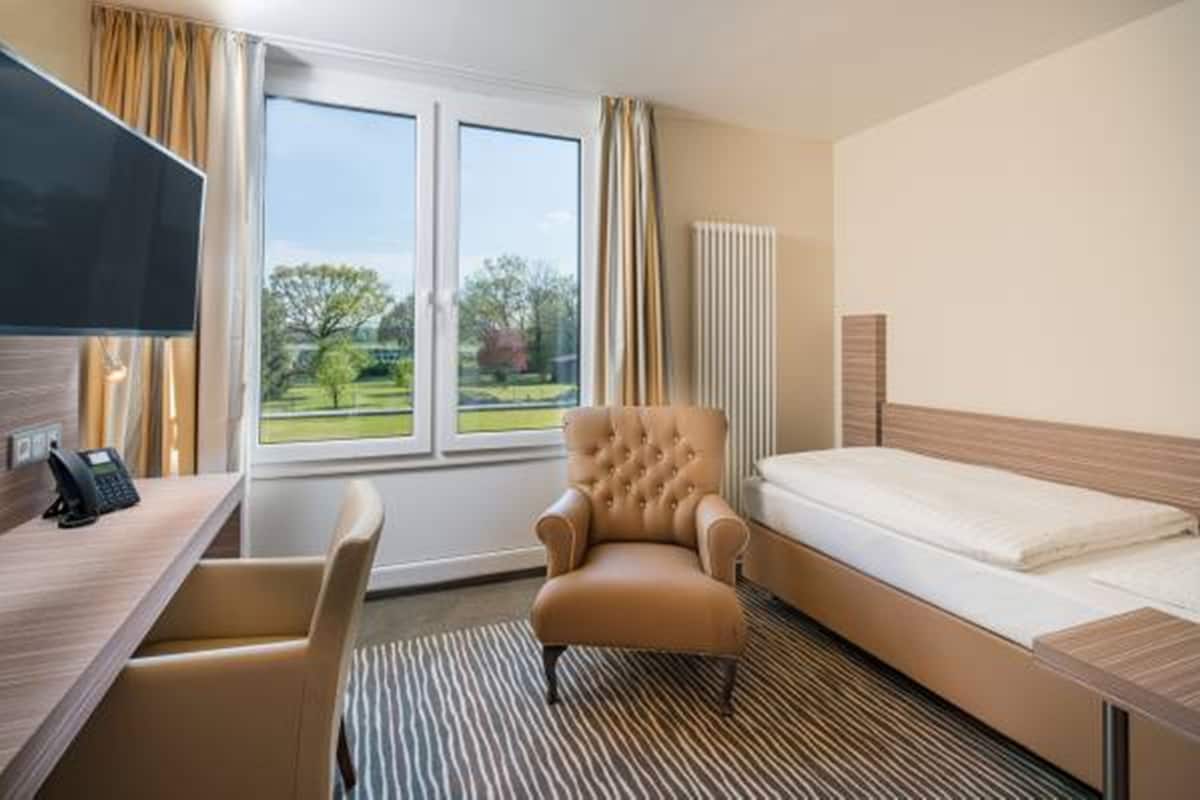 comfort single room | hypo-allergenic bedding, in-room safe, desk, blackout curtains