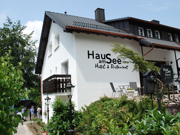 A white building with a sign reading "HauSee Hotel & Restaurant". - Hotel Haus am See (Sinzheim)