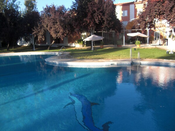 Seasonal outdoor pool, pool umbrellas, pool loungers