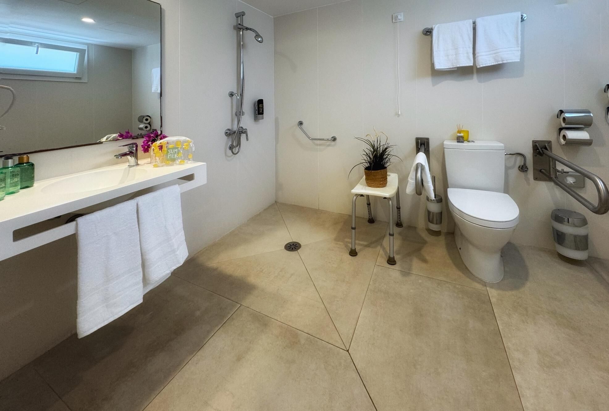 Une salle de bain moderne équipée d’une douche, de toilettes et d’un lavabo.