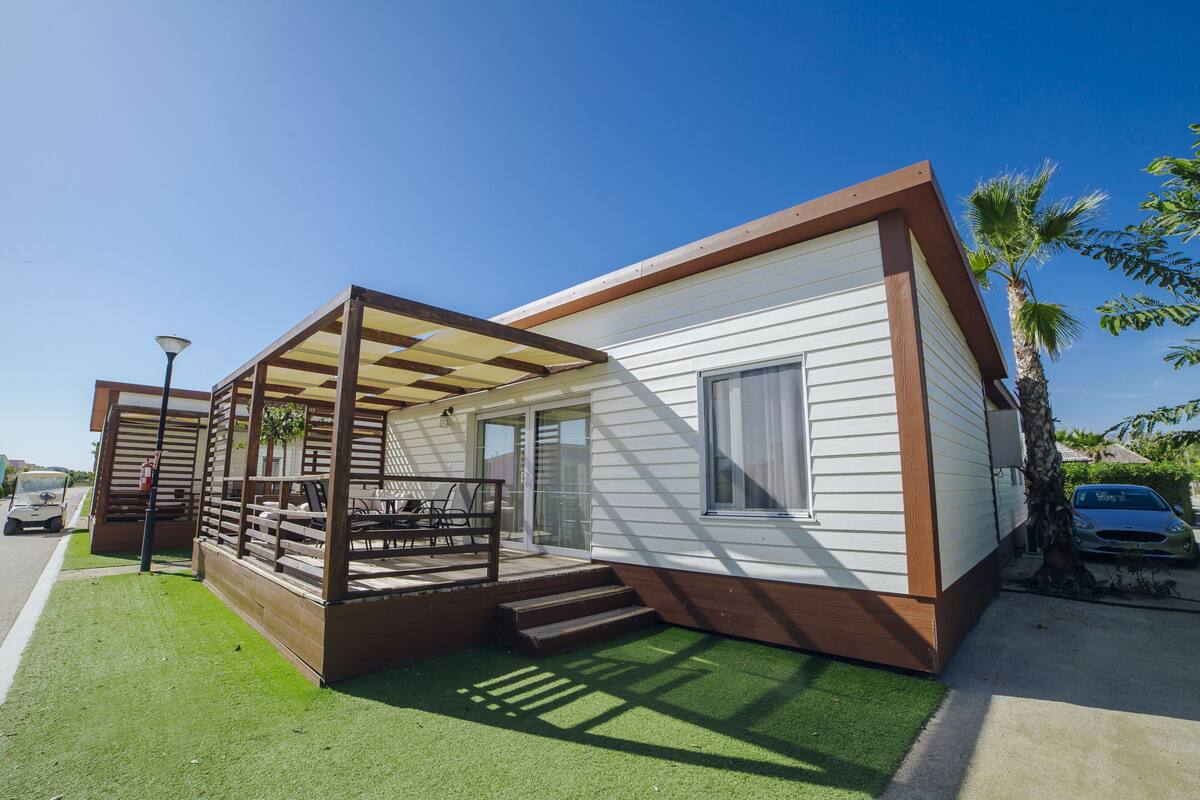 A single-story house with a covered patio, a small deck, and a carport.