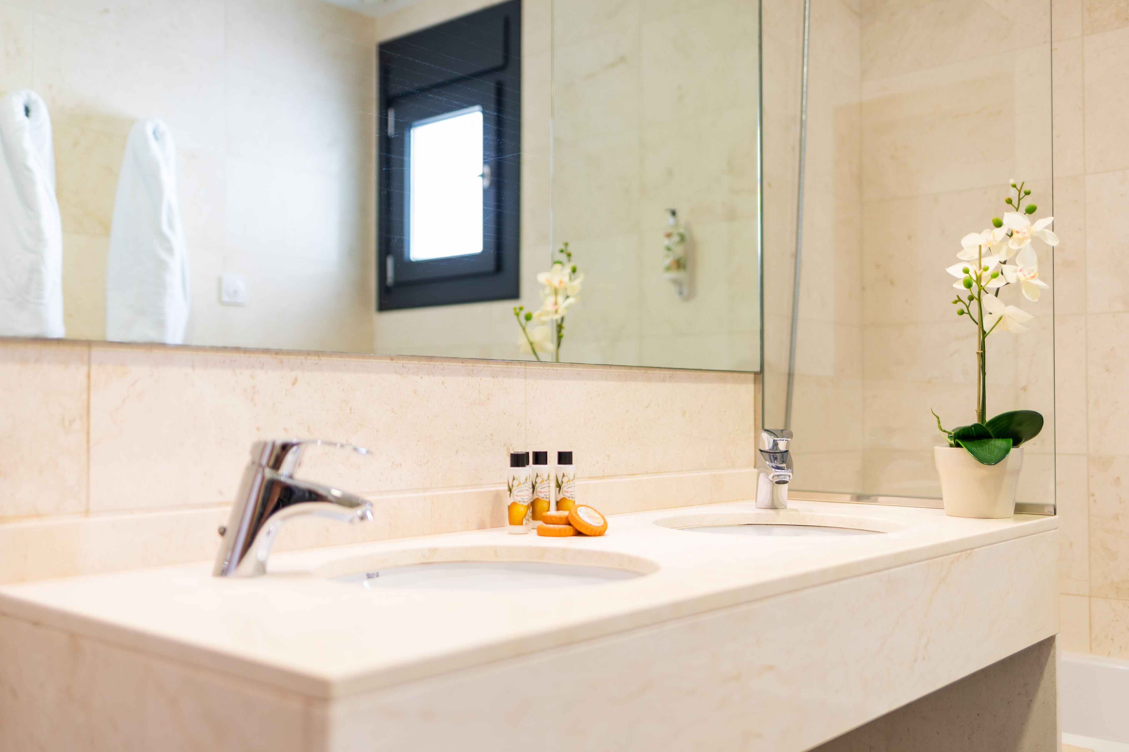 designer toiletries, hair dryer, towels, soap