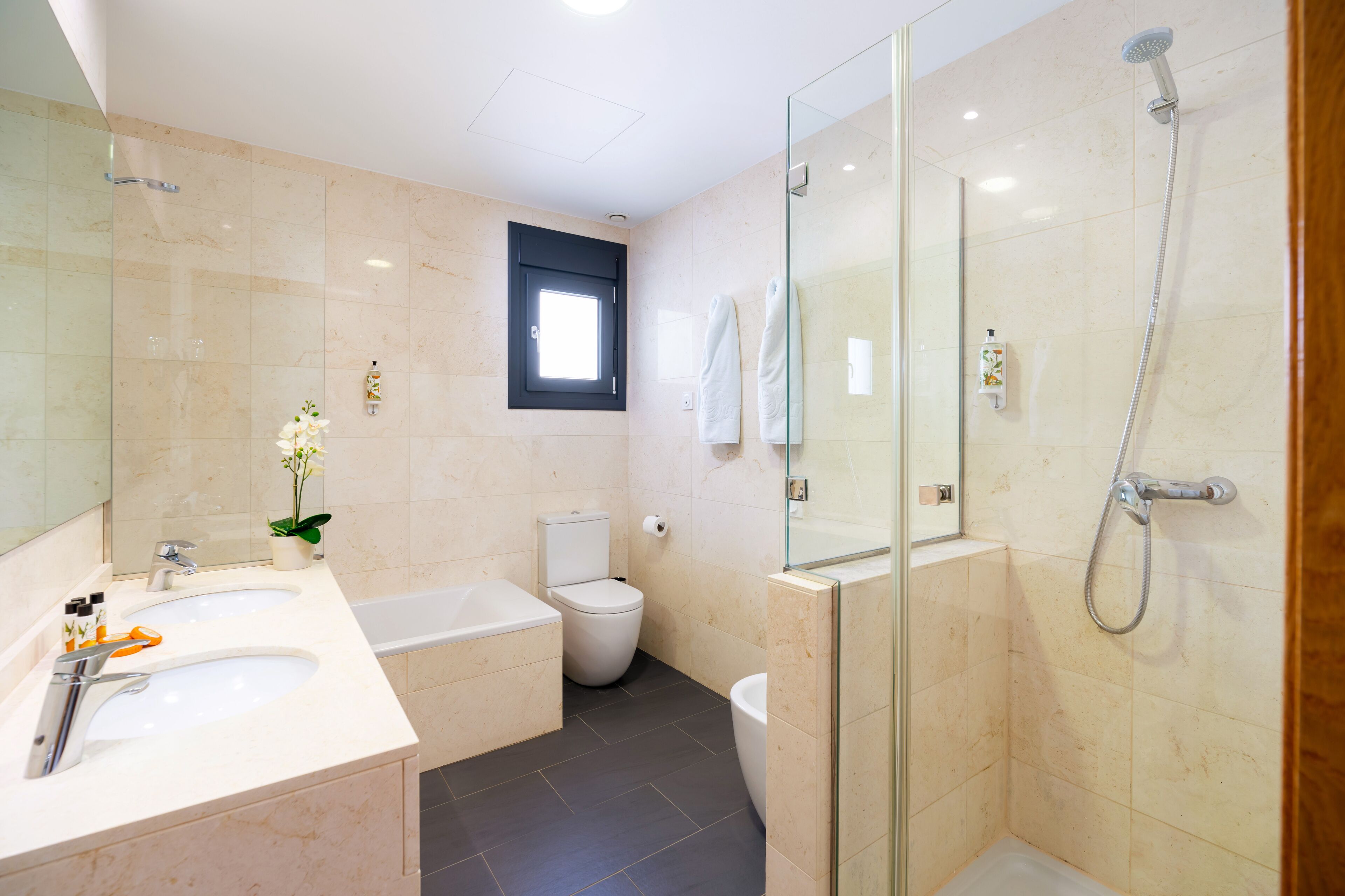 designer toiletries, hair dryer, towels, soap