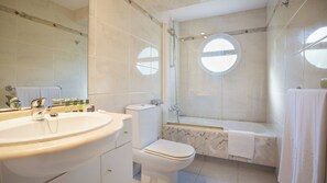 A modern bathroom with a large sink, toilet, and bathtub. - Es Pi2 (Formentera)