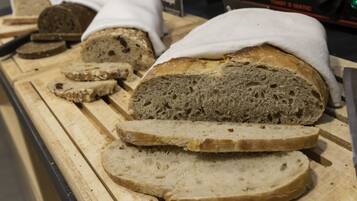 A display of sliced bread on a wooden cutting board.