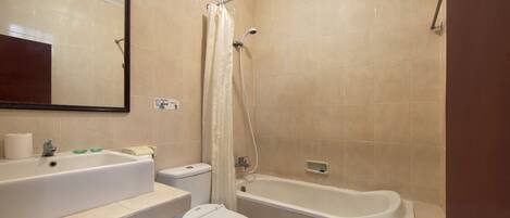 A bathroom with a sink, toilet, and bathtub.