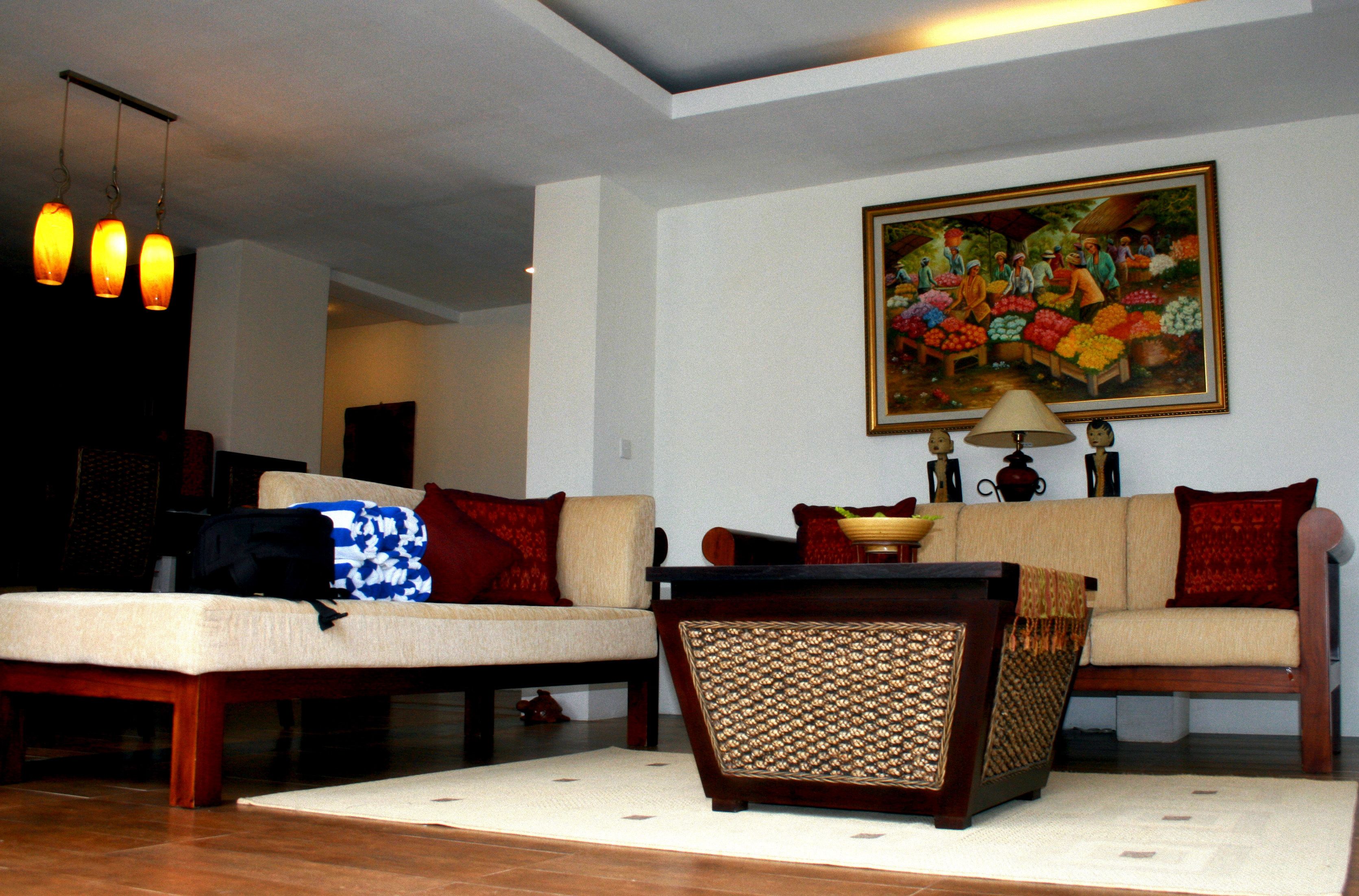 A living room with two sofas, a coffee table, and a painting on the wall.