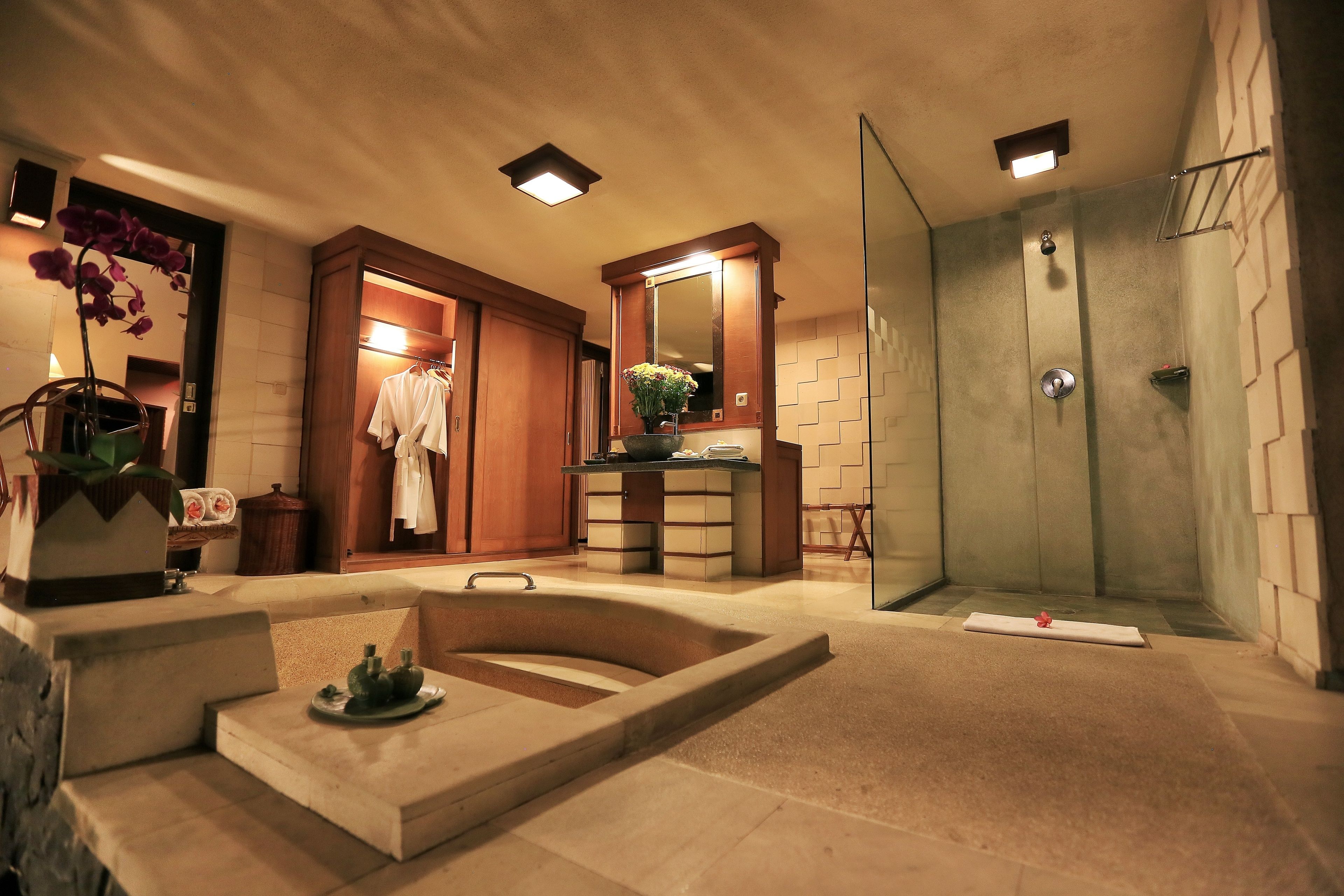 A modern bathroom with a bathtub, shower, and a vanity area.