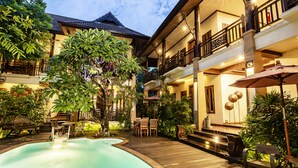 A courtyard with a swimming pool, wooden deck, and outdoor seating area. - Amata Lanna Chiang Mai One Member of The Secret Retreat (Chiang Mai)