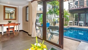 A room with a dining area, a large sliding glass door leading to a pool area, and a view of the outside balcony.