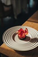 A plate with a dessert on a wooden table.