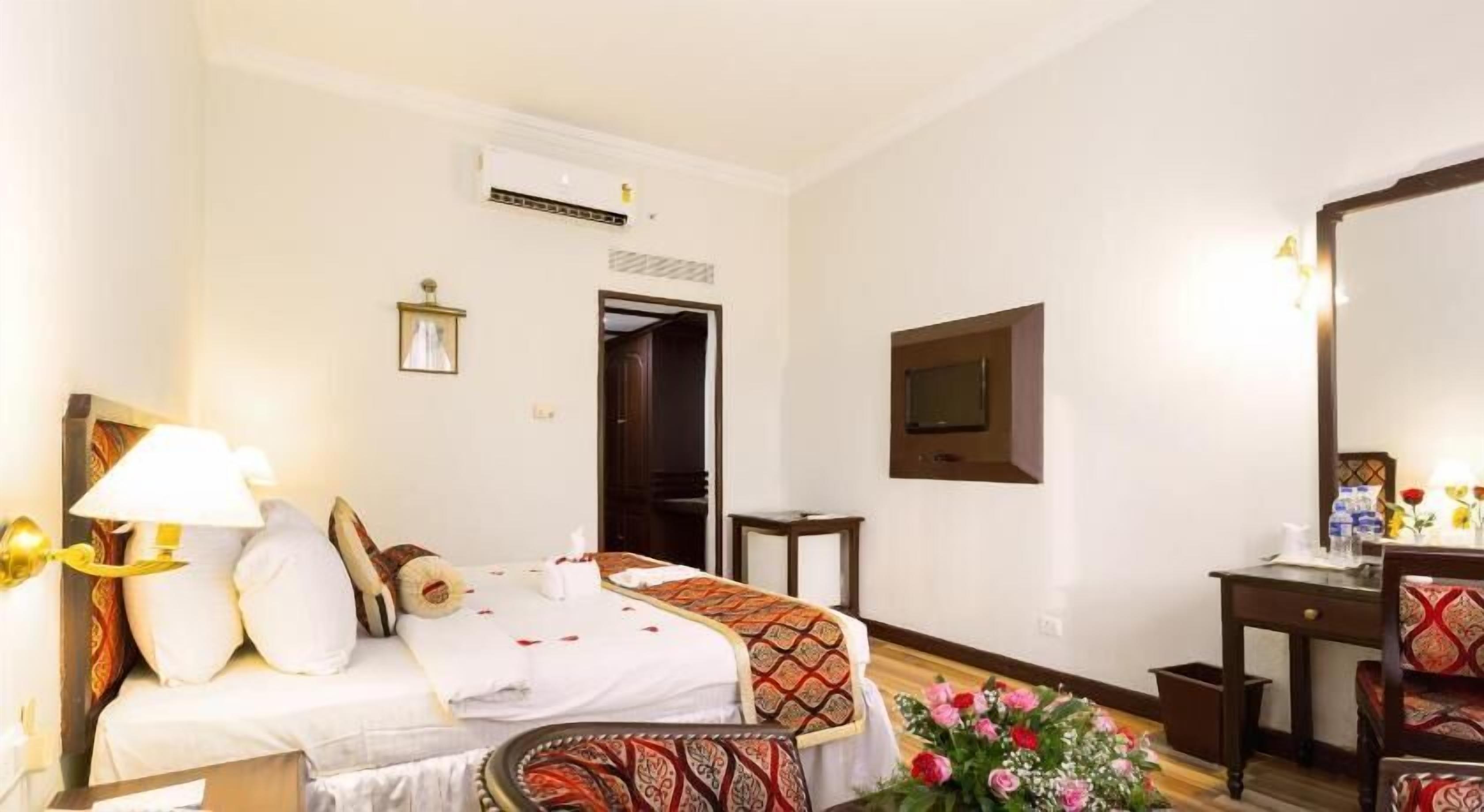 أغطية فراش متميزة وميني بار وخزنة داخل الغرفة ومكتب