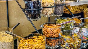 A buffet with various food items like nuts, seeds, and dried fruits.