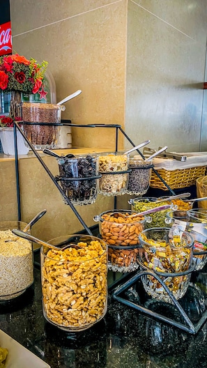 A buffet with various food items like nuts, seeds, and dried fruits.