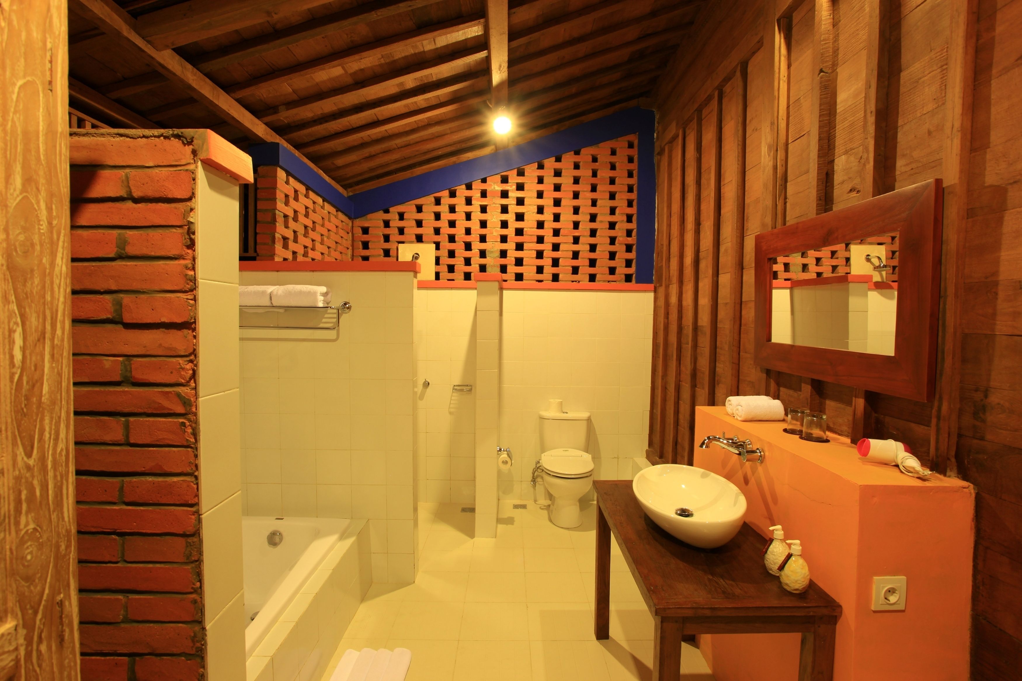 A bathroom with a bathtub, toilet, and sink.