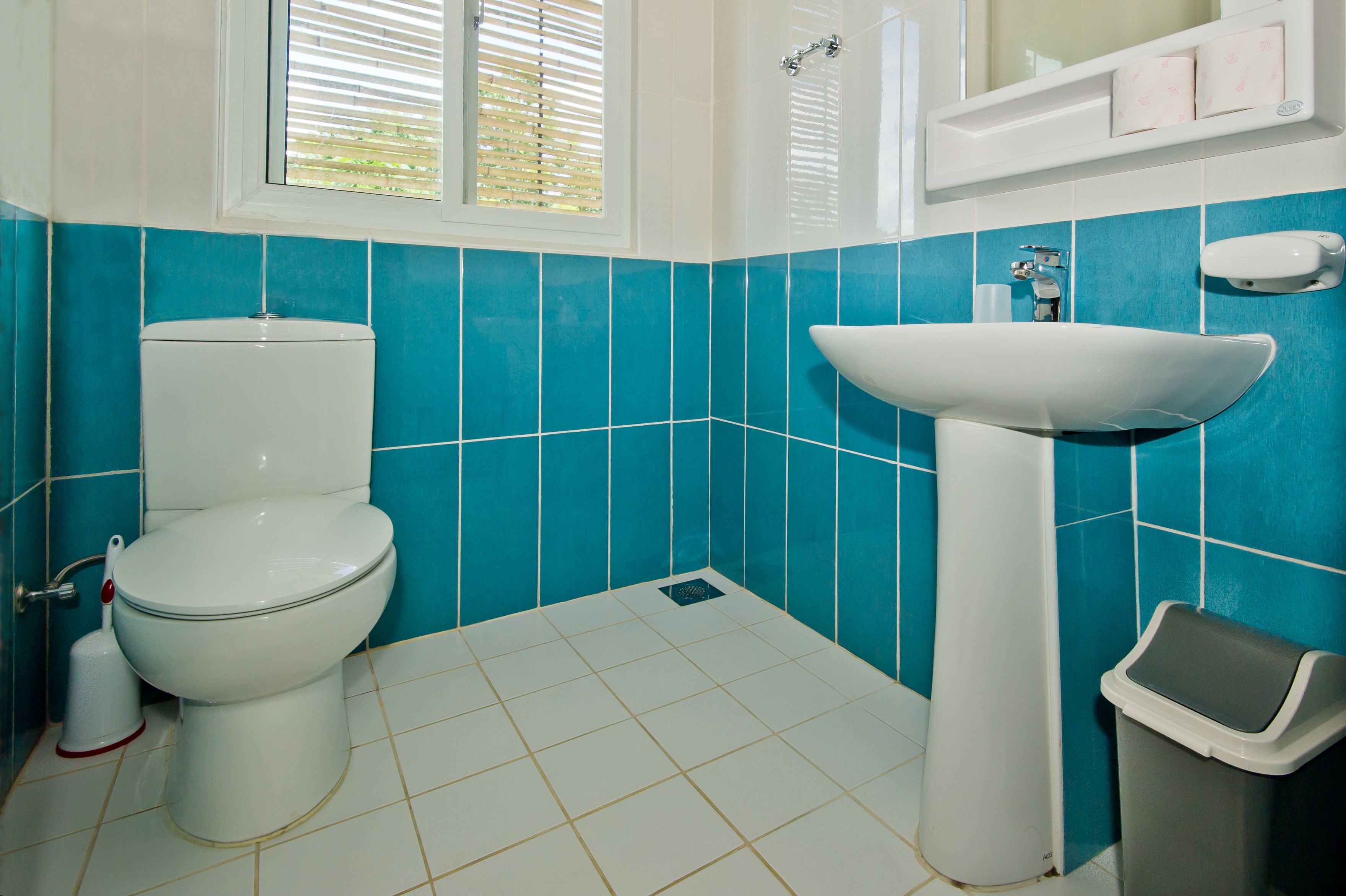 deluxe room | bathroom | shower, rainfall showerhead, slippers, towels