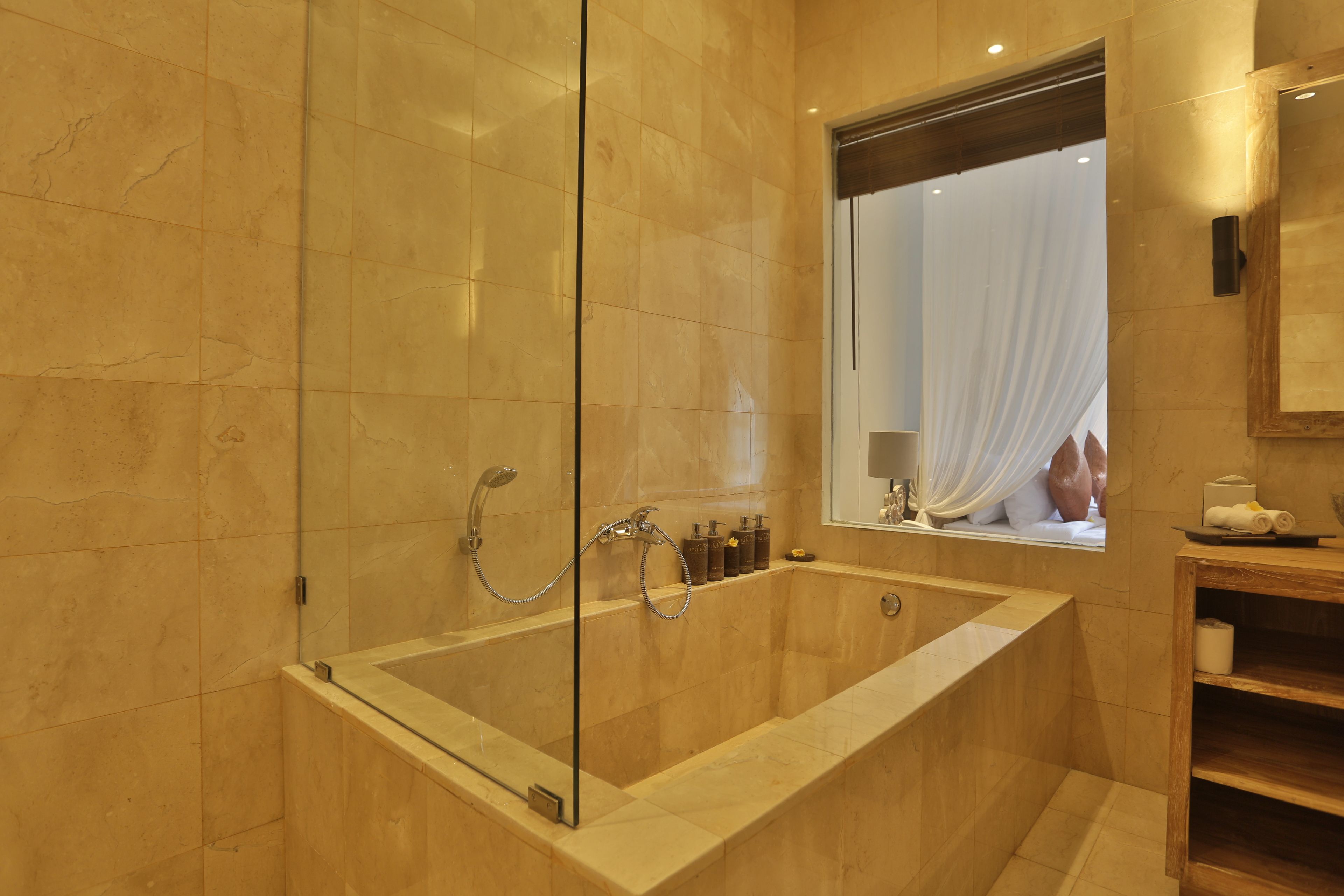 deep-soaking bathtub, rainfall showerhead, designer toiletries