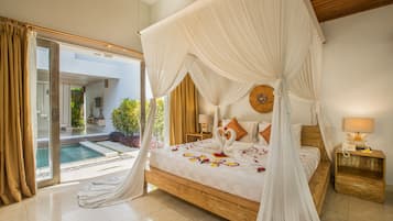 A spacious bedroom with a large bed, a canopy, and a view of a swimming pool.