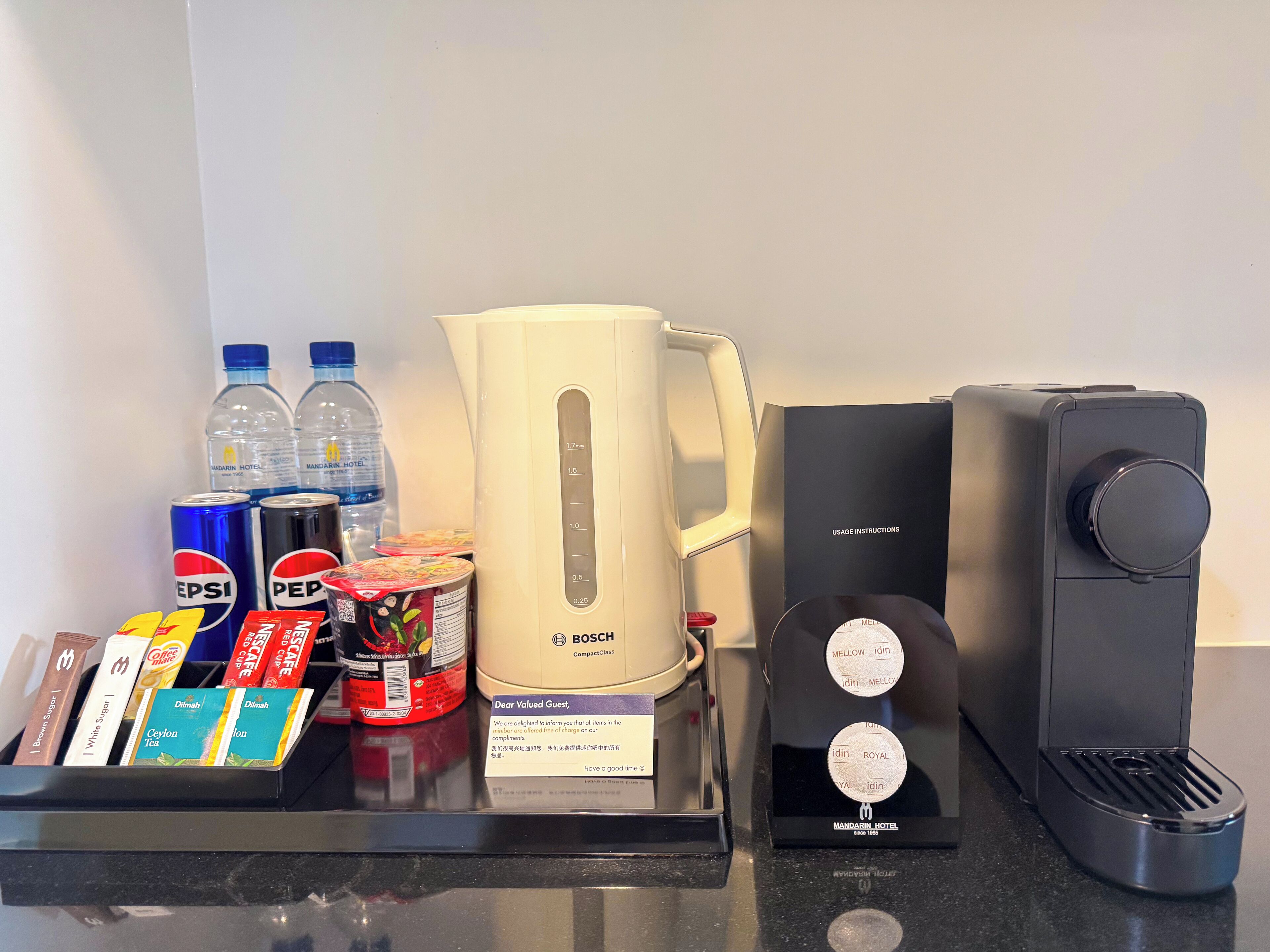 A coffee station with a Bosch compact coffee maker, a water dispenser, and a coffee machine with usage instructions.