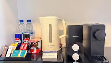 A coffee station with a Bosch compact coffee maker, a water dispenser, and a coffee machine with usage instructions.