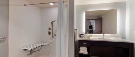 A modern bathroom with a shower, toilet, and sink.