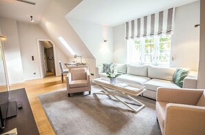 Suite (Spa) | Living area | 48-inch flat-screen TV with digital channels, TV, books - WEISSENHAUS Private Nature Luxury Resort (Wangels)