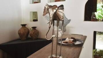 Una scultura di un elefante in metallo con un fiocco su un tavolo di legno.